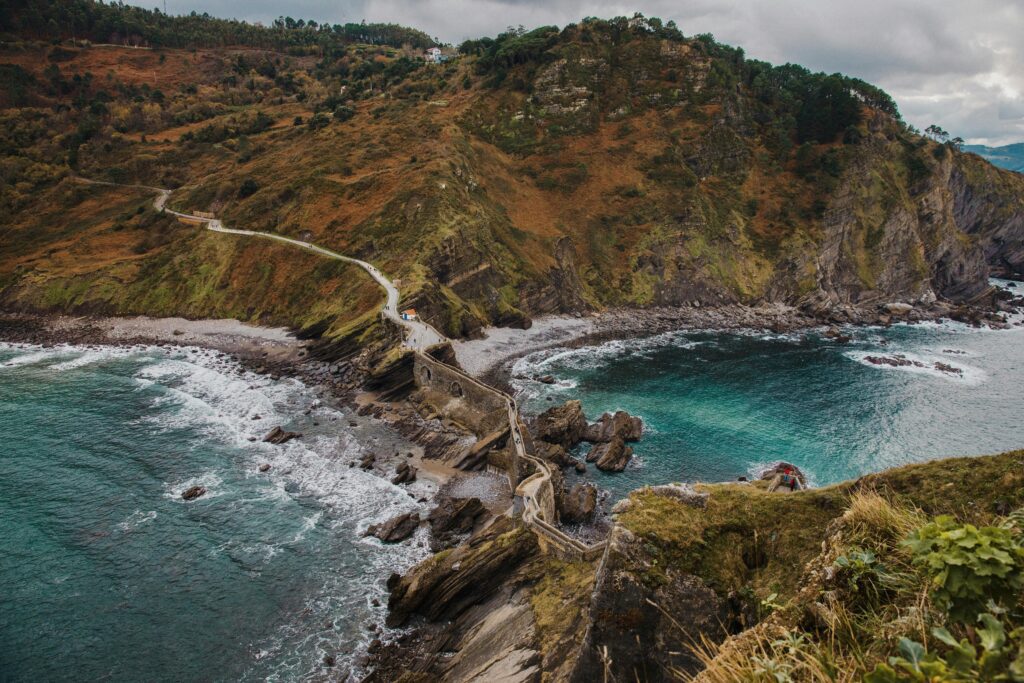 A breathtaking view of Gaztelugatxe's rugged coastline, showcasing its scenic cliffs and turquoise waters.